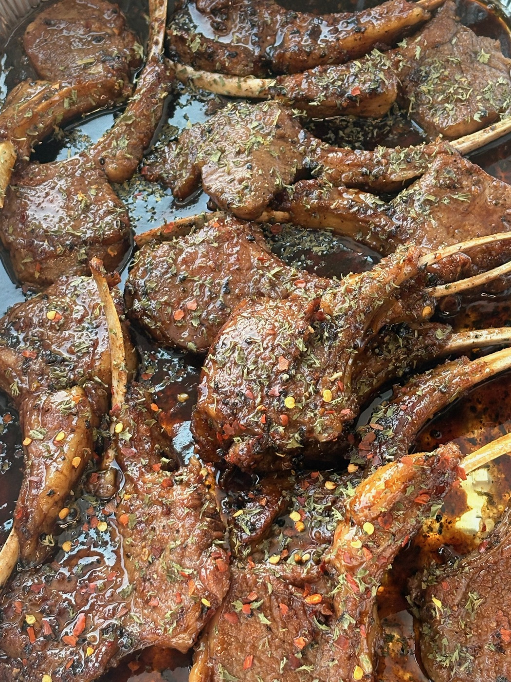 Glazed and seasoned lamb chops prepared for catering